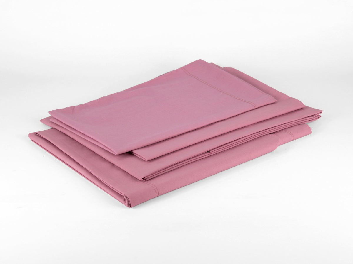 Completo letto MAREA da 1 piazza e mezza a tinta unita rosa con lenzuola e federa coordinata.